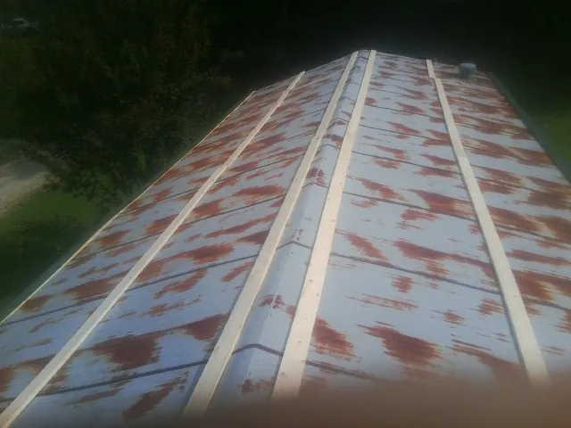 Rusted metal roof panels with new wood purlins before replacement — Storm Damage Roof Repair in Muscoda by Roofing Brothers